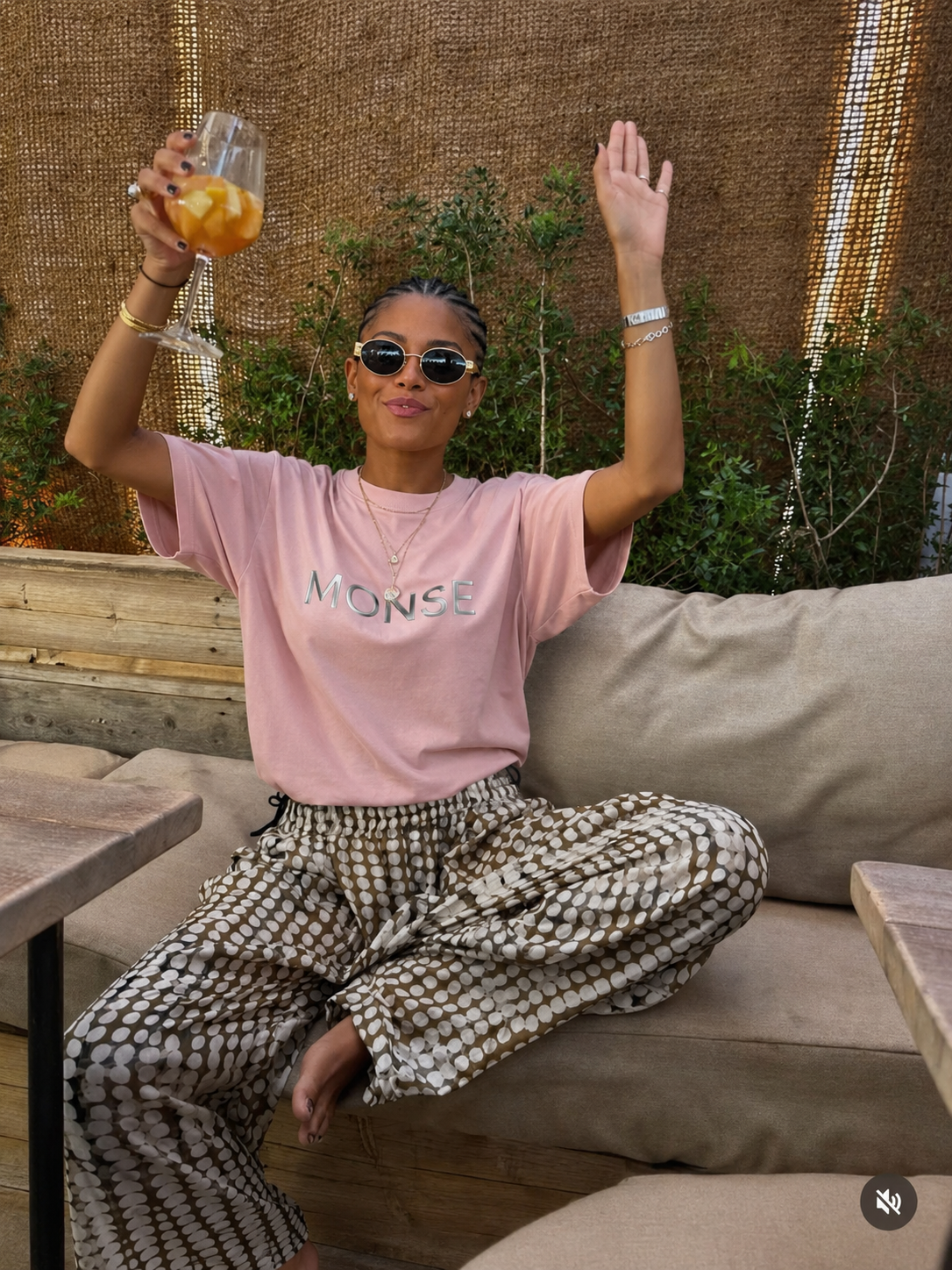 MONSE tee at a bistro, a glass held up mid-afternoon