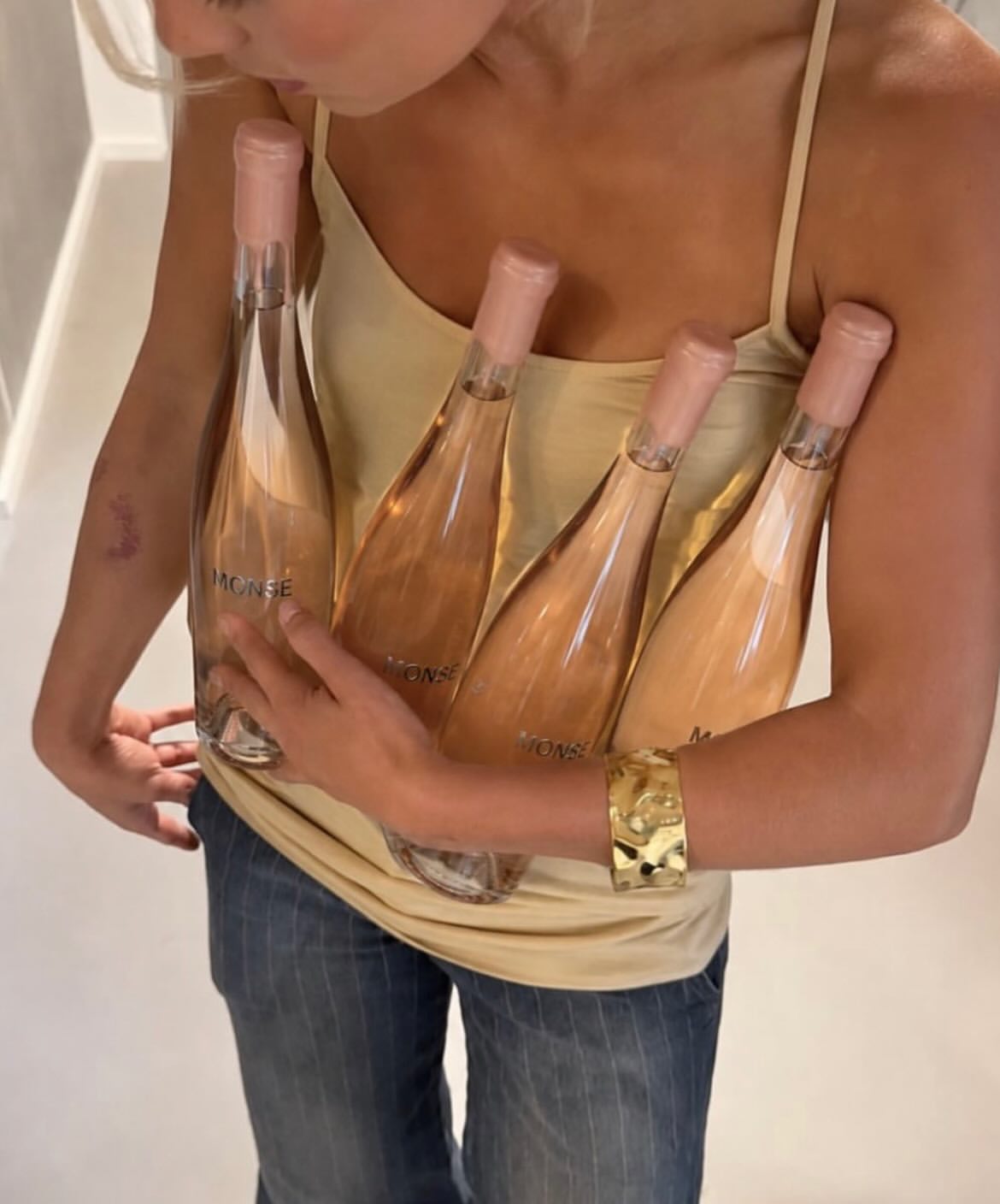 An armful of MONSE bottles