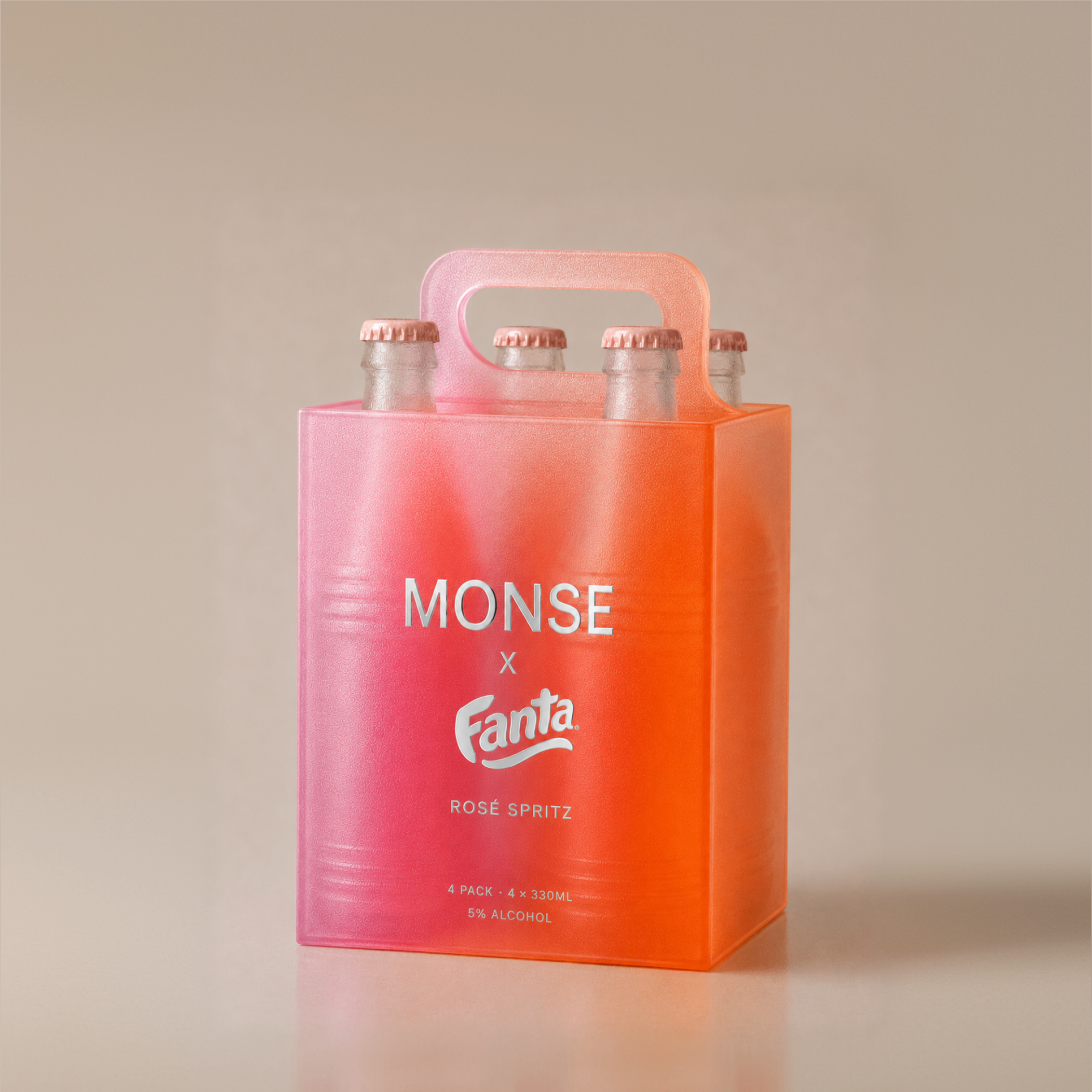 Frosted pink-to-orange MONSE x Fanta Rosé Spritz 4-pack carrier on a warm neutral background